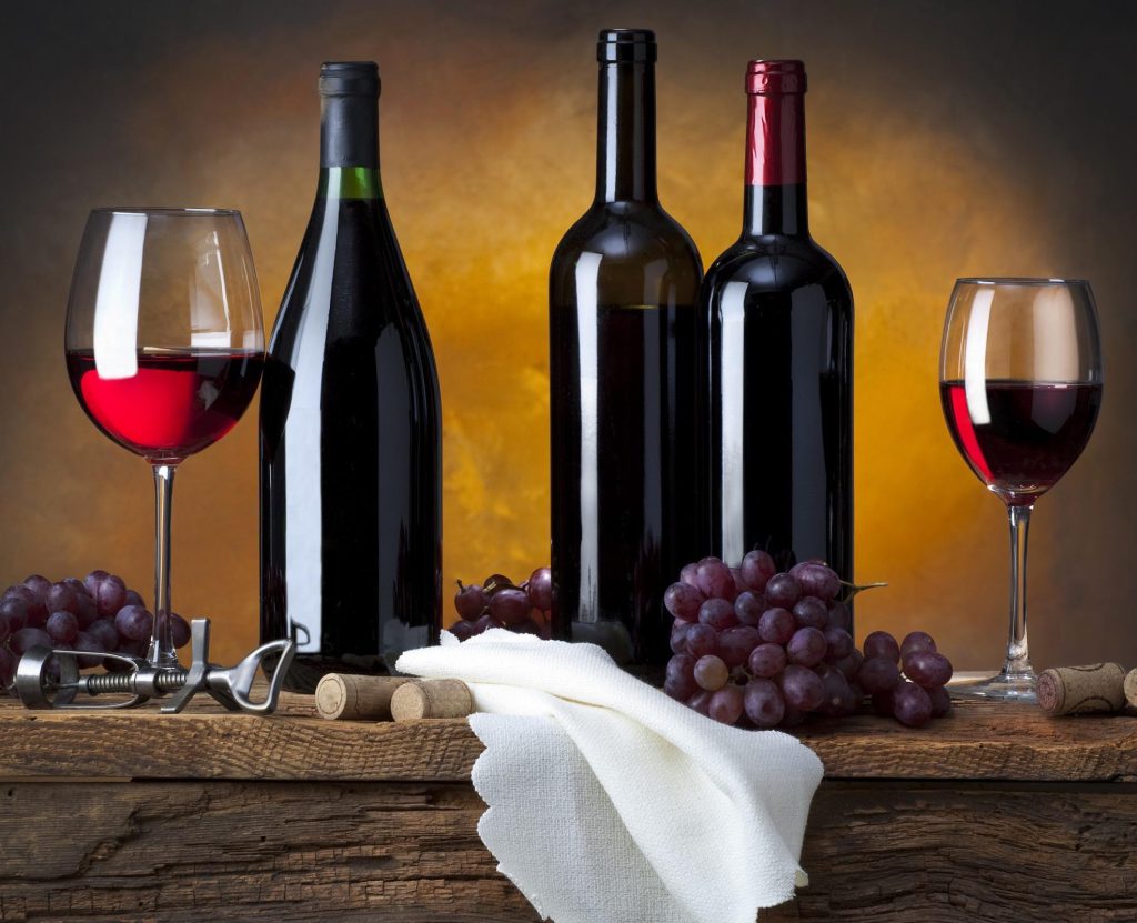 Wine bottles and glasses on a wooden table